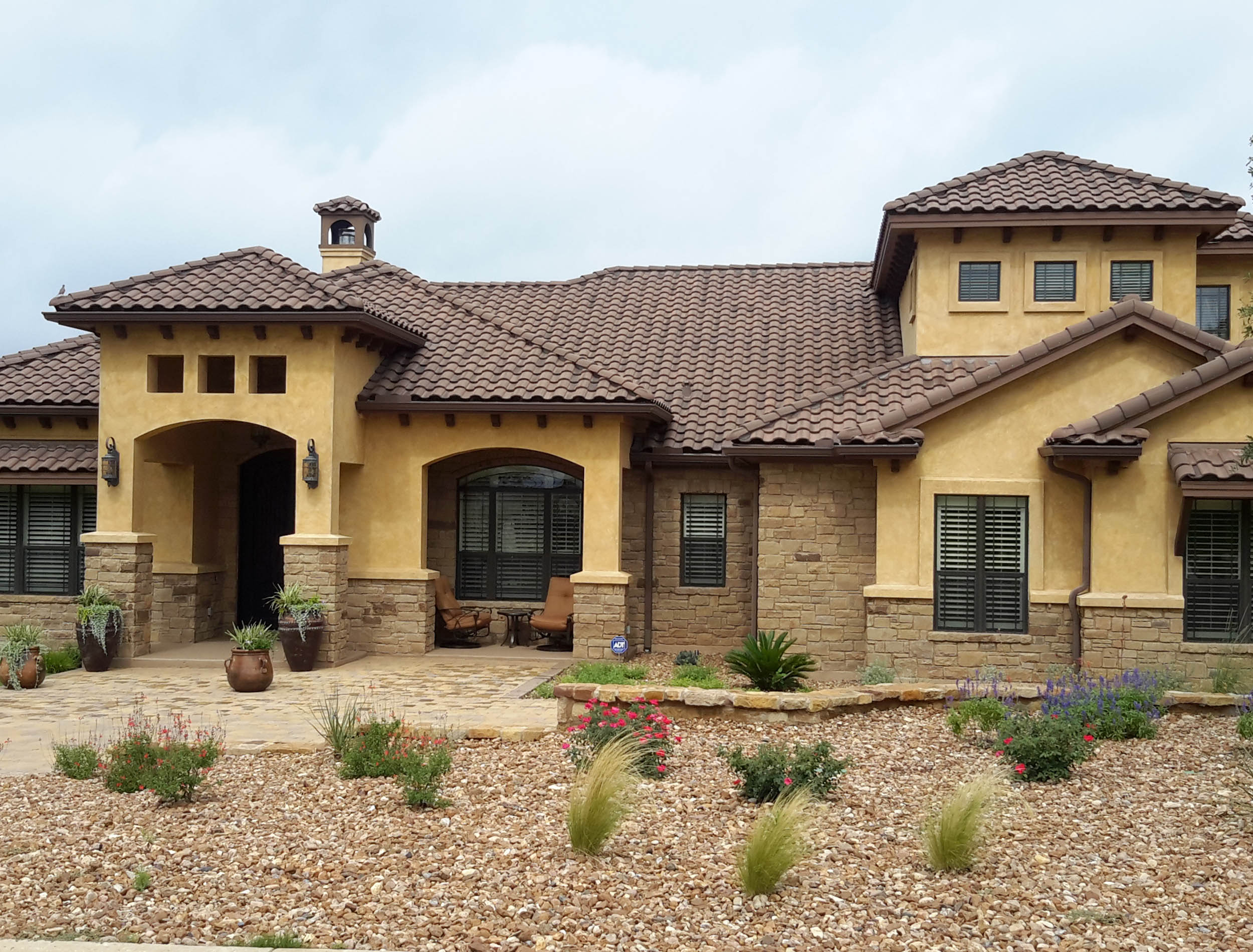 A home in Round Rock, Texas with a new Tile roof installed by TAG Roofing & Exteriors.