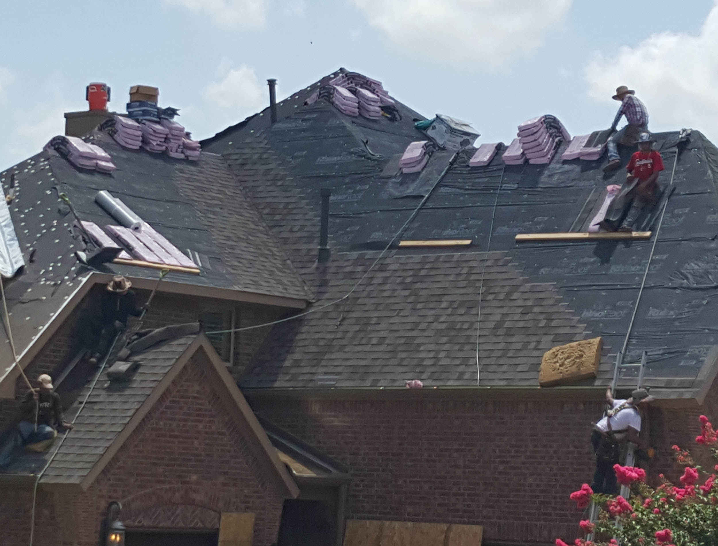 A TAG Roofing & Exteriors crew installing new shingles on a roof in Georgetown, Texas.