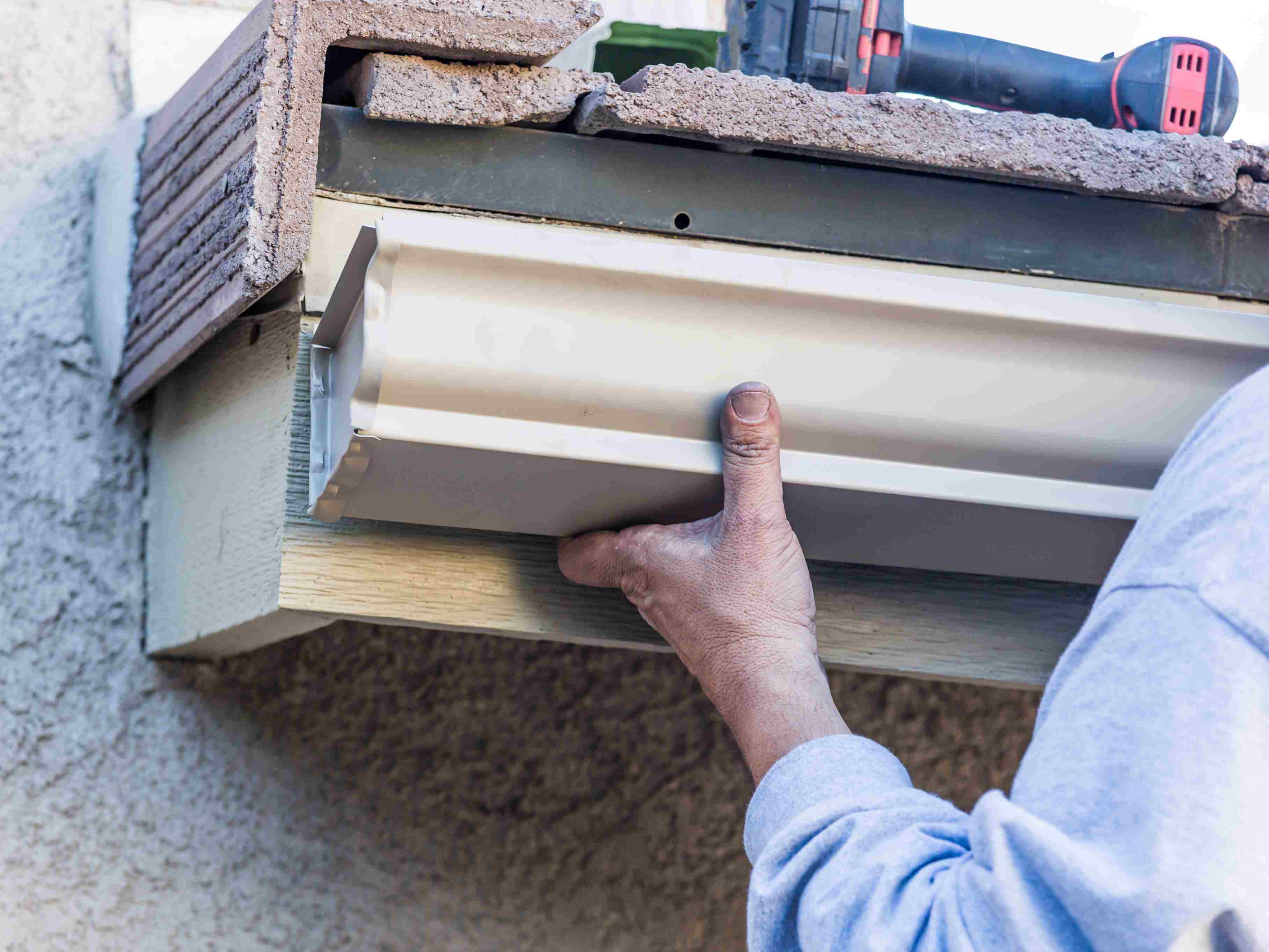 Man repairing a gutter system